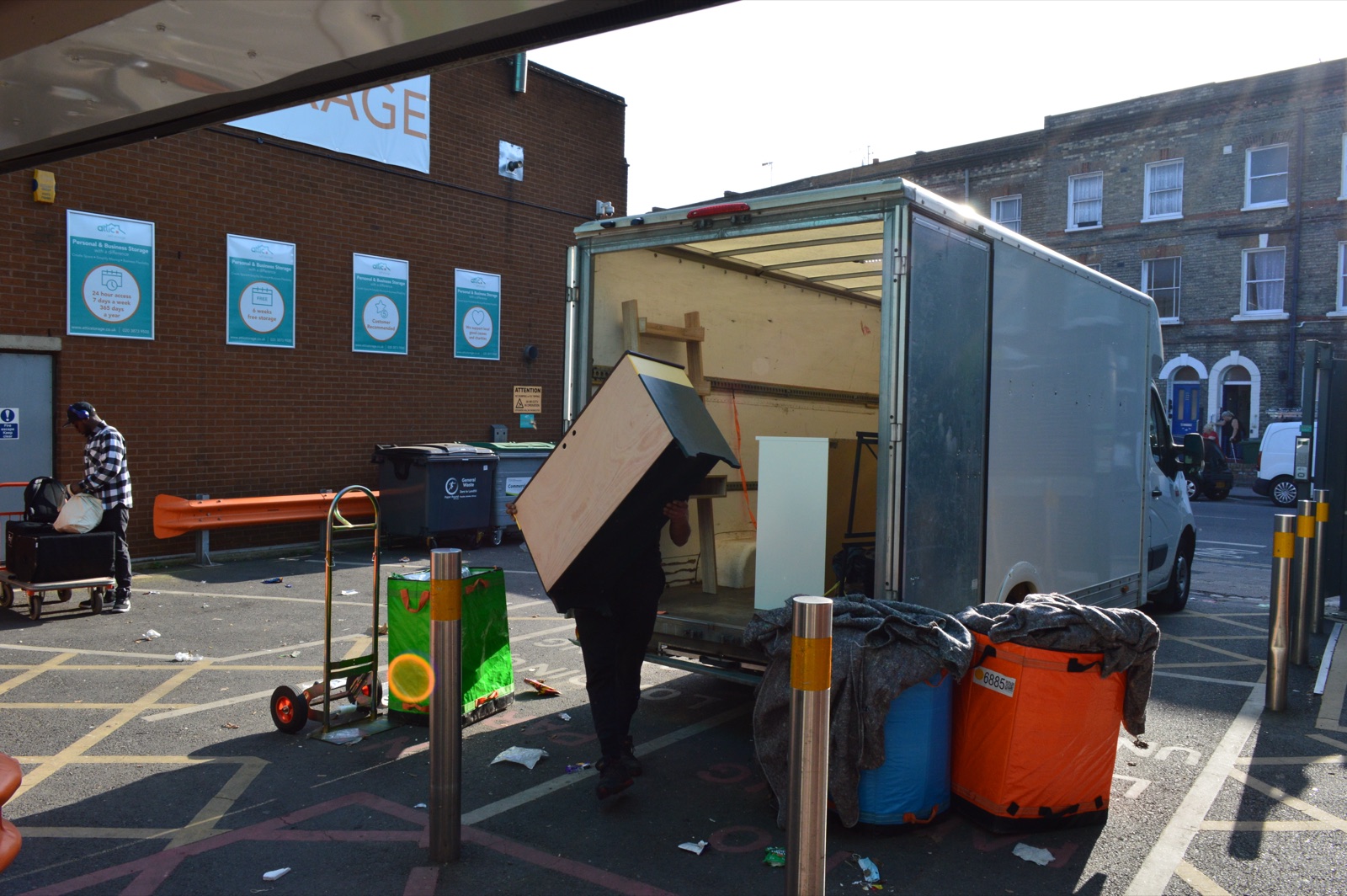 Cabinet and household furniture being loaded carefully into a Luton van