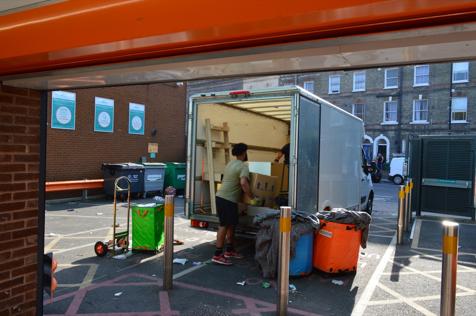 Covered furniture being loaded into a Luton van