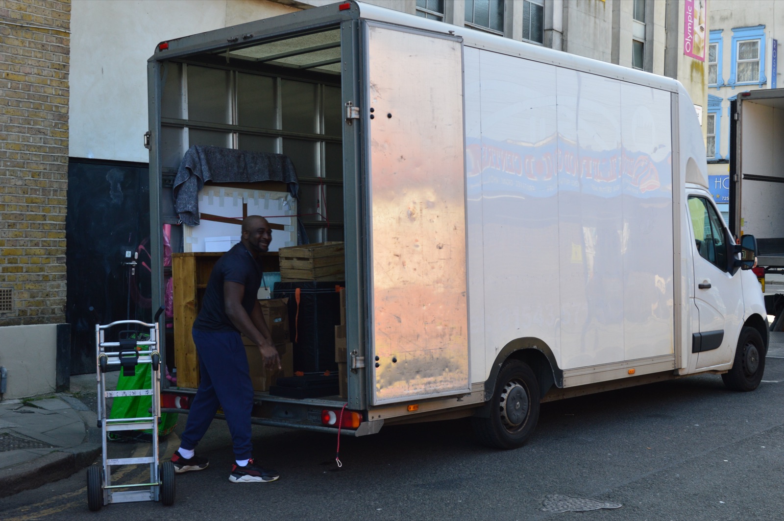 Friendly mover standing by the Luton van during a removal job