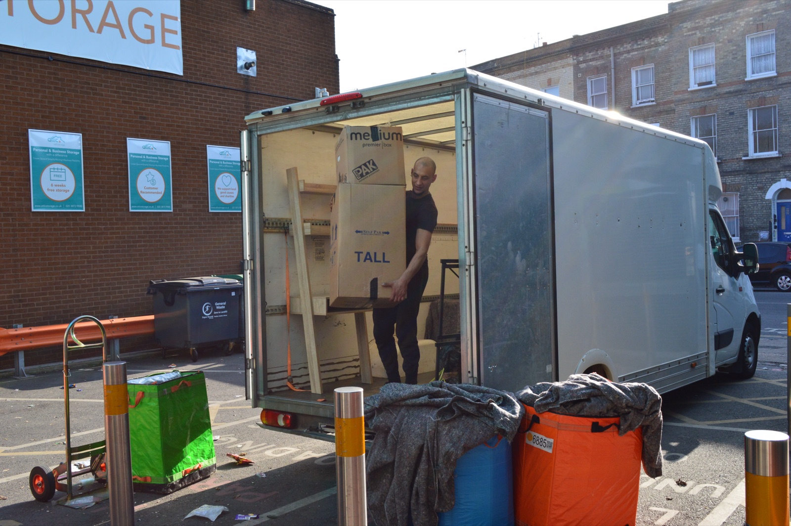 Tall moving box being loaded into a Luton van