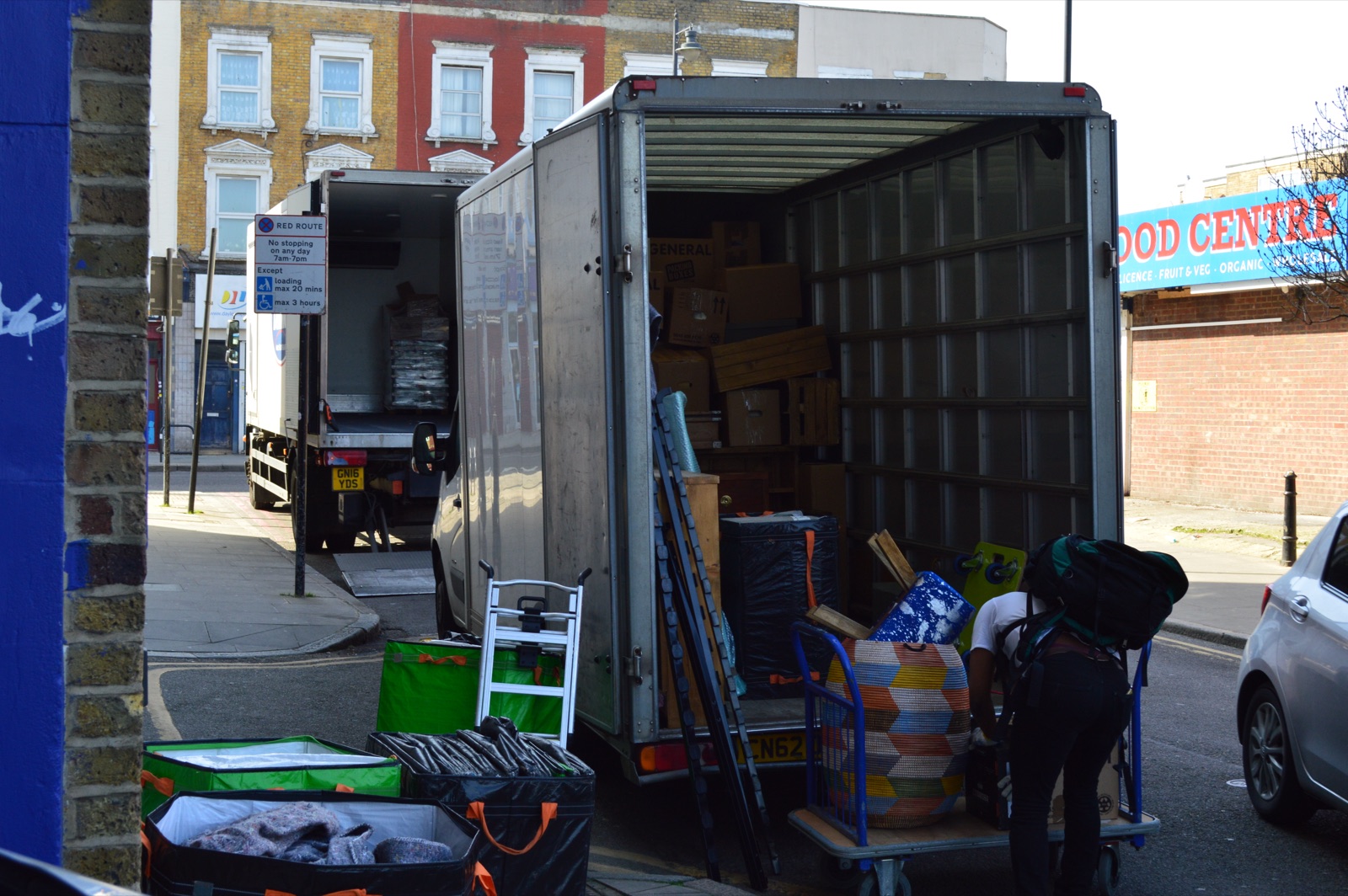 Two Luton vans parked on a street for a larger removal job