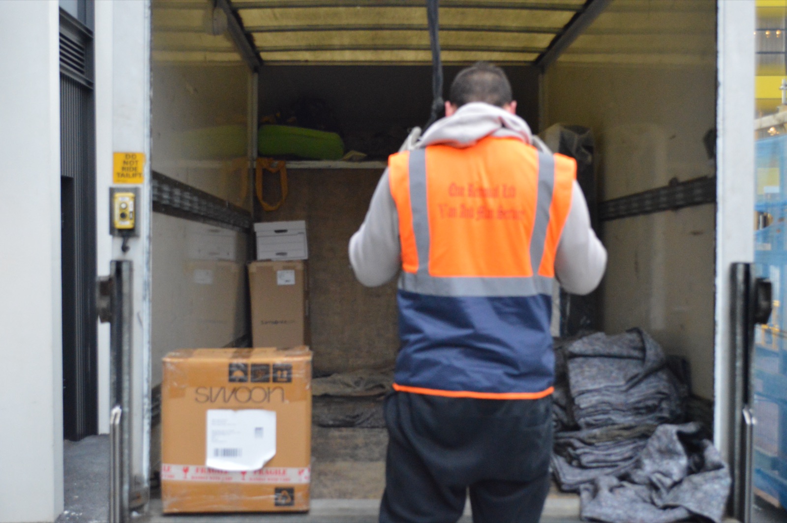 Mover loading boxes into the back of a Luton van